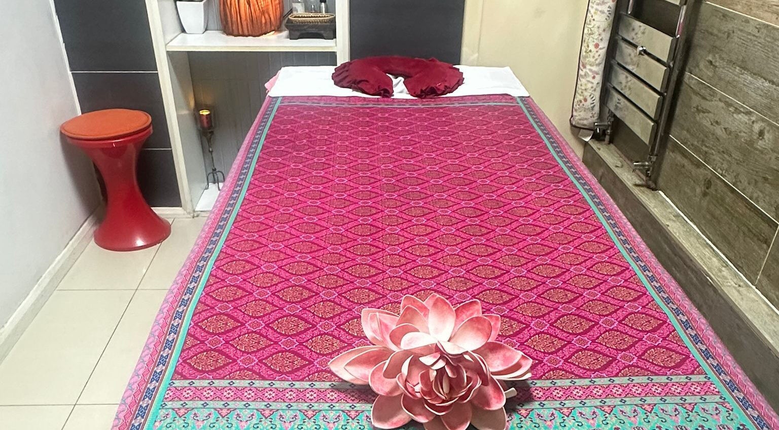 Cozy massage bed at Karaket Thai Massage, London, England, GB adorned with a lotus flower.
