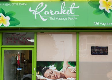 Entrance of Karaket Thai Massage in London, England, GB, with vibrant sign and inviting decor.