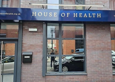Street view of The Makeover Clinic, Birmingham, England, GB showcasing brick exterior with large windows.