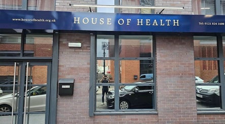 Street view of The Makeover Clinic, Birmingham, England, GB showcasing brick exterior with large windows.