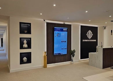 Sleek reception at The Makeover Clinic, Birmingham, England, GB with modern decor and ambient lighting.