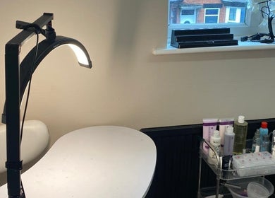 She'la's nail care setup in Hasland, England, GB with products and modern lighting.