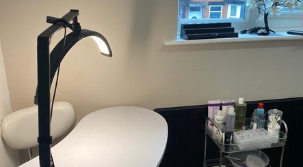 She'la's nail care setup in Hasland, England, GB with products and modern lighting.