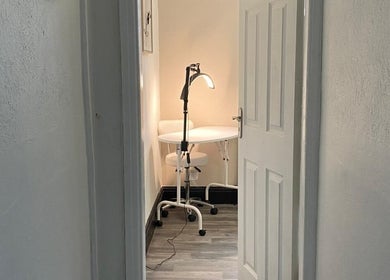 Cozy treatment space at She'la's, Hasland, England, GB with a lamp-lit table and chair setup.