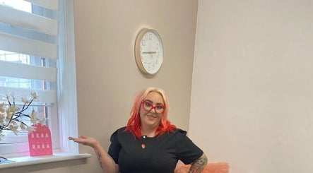 Welcoming stylist at She'la's, Hasland, England, GB, in a cozy beauty room.