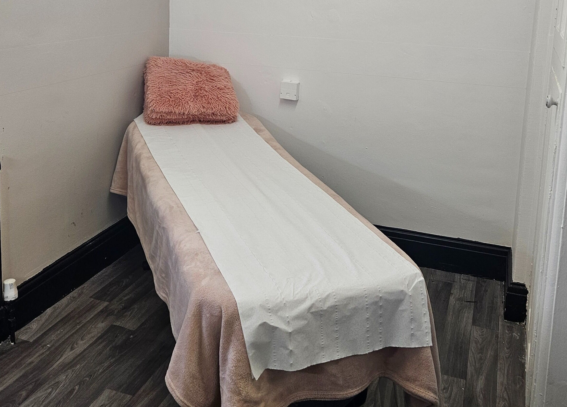 Cozy massage table at She'la's in Hasland, England, GB for relaxation and therapy.