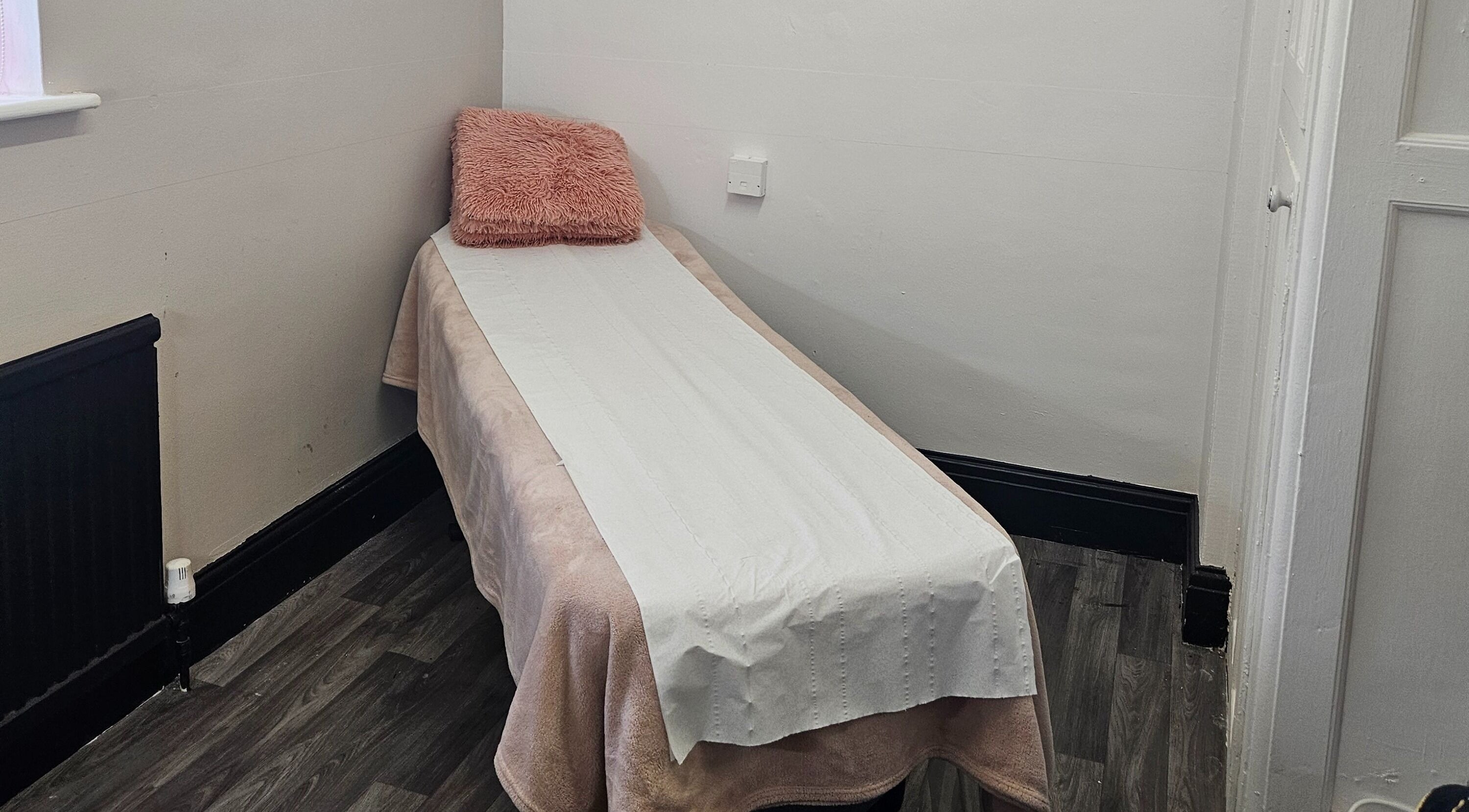 Cozy massage table at She'la's in Hasland, England, GB for relaxation and therapy.
