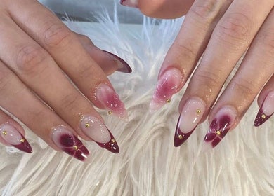 Stylish red and gold nail art at Adore Nail & Spa in Belmore, New South Wales, AU.
