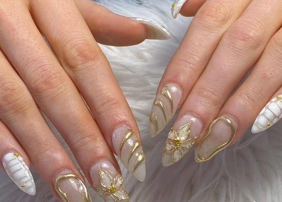 Elegant gold nail art at Adore nail & spa in Belmore, New South Wales, AU, showcasing intricate design.