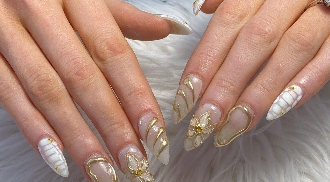 Elegant gold nail art at Adore nail & spa in Belmore, New South Wales, AU, showcasing intricate design.