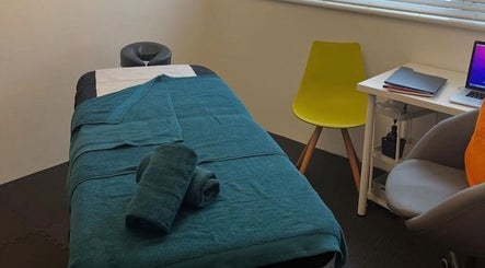Relaxing massage room at TH Performance Therapy, Cornwall Sports Massage in Padstow, England, GB with teal accents.