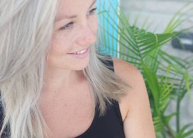 A woman with silver hair smiles at Halo Mobile Hair & Make-up, Kingston, Ontario, CA.