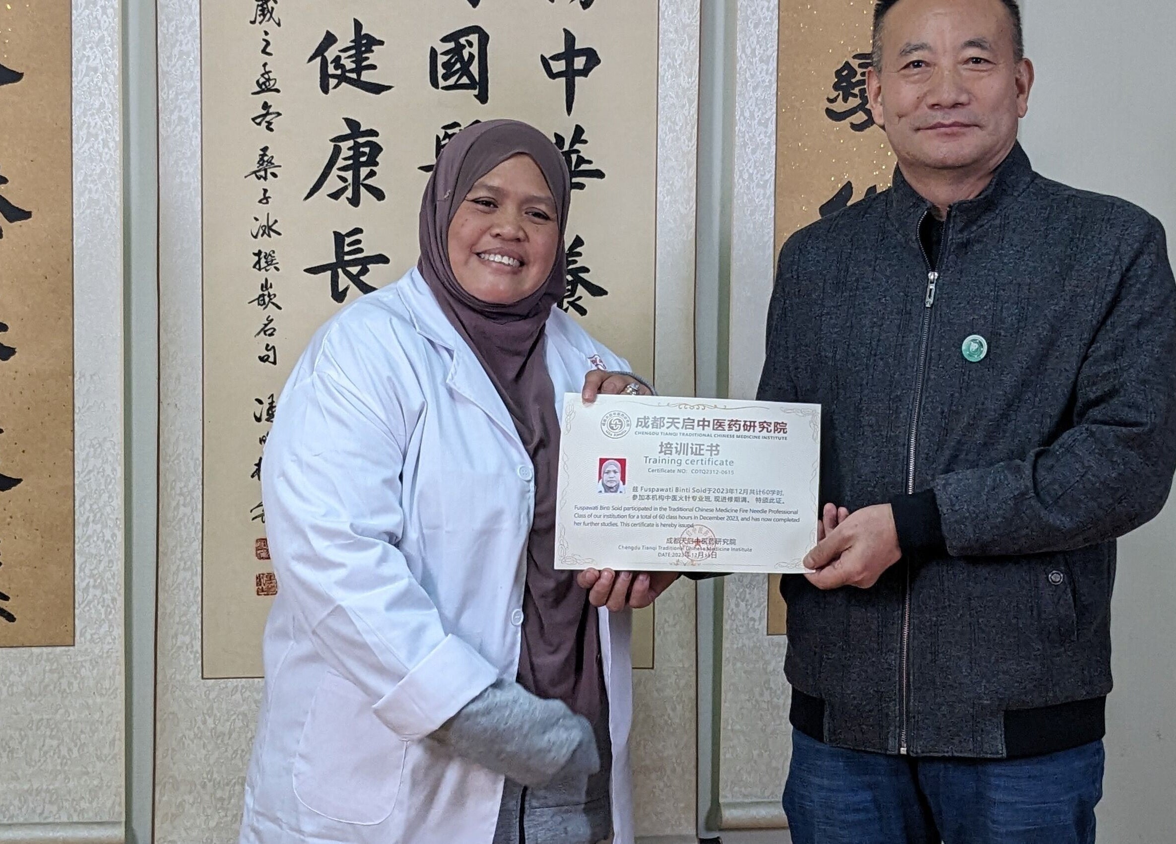 Staff at Al Raed Wellness Centre in Batu Caves, Kuala Lumpur, MY holding a training certificate.
