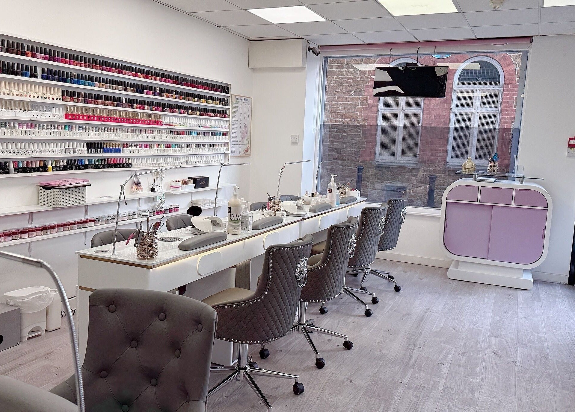 Interior of Wendy’s Nails in Kettering, England, GB showcasing a chic nail bar and wall of colorful polishes.