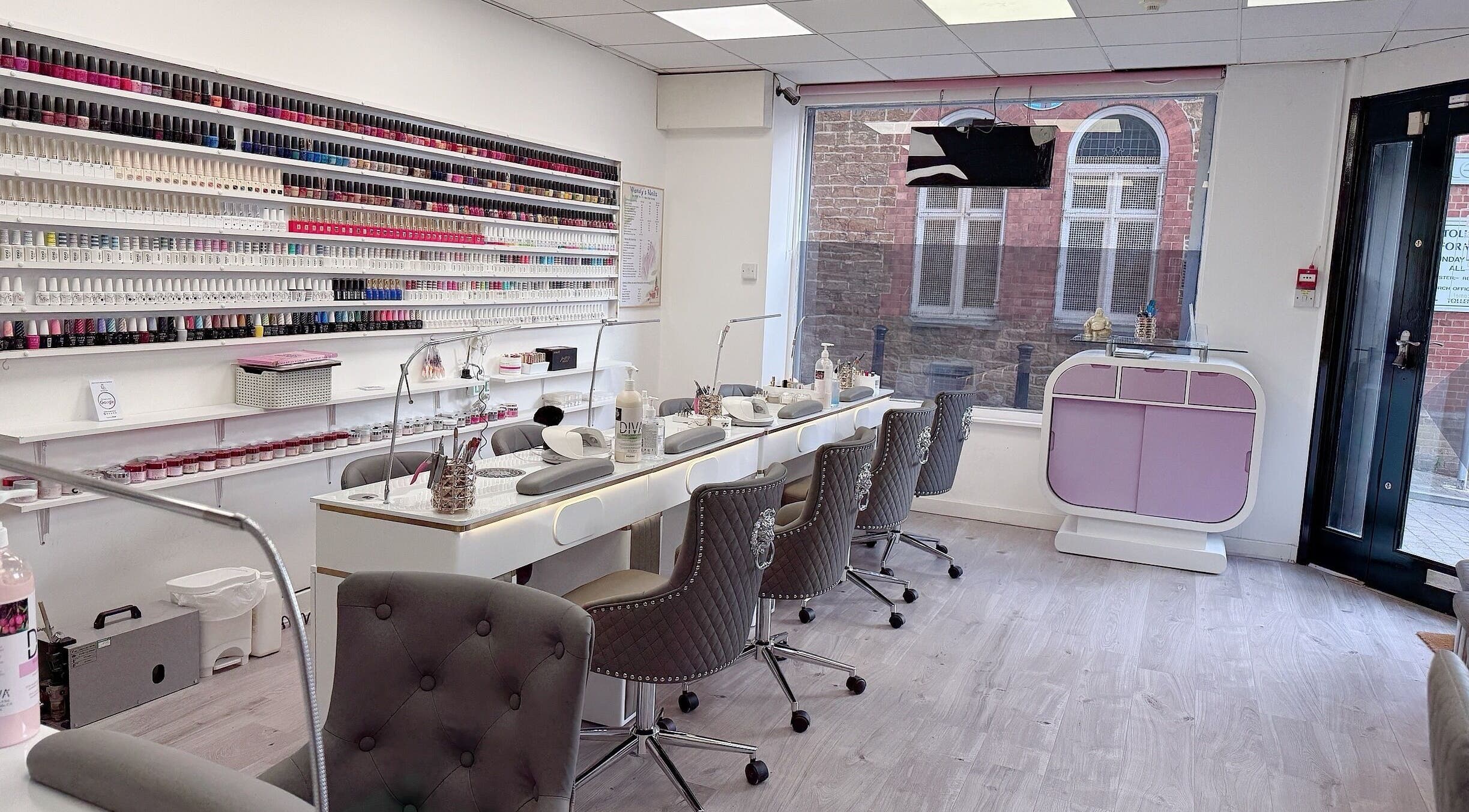 Interior of Wendy’s Nails in Kettering, England, GB showcasing a chic nail bar and wall of colorful polishes.