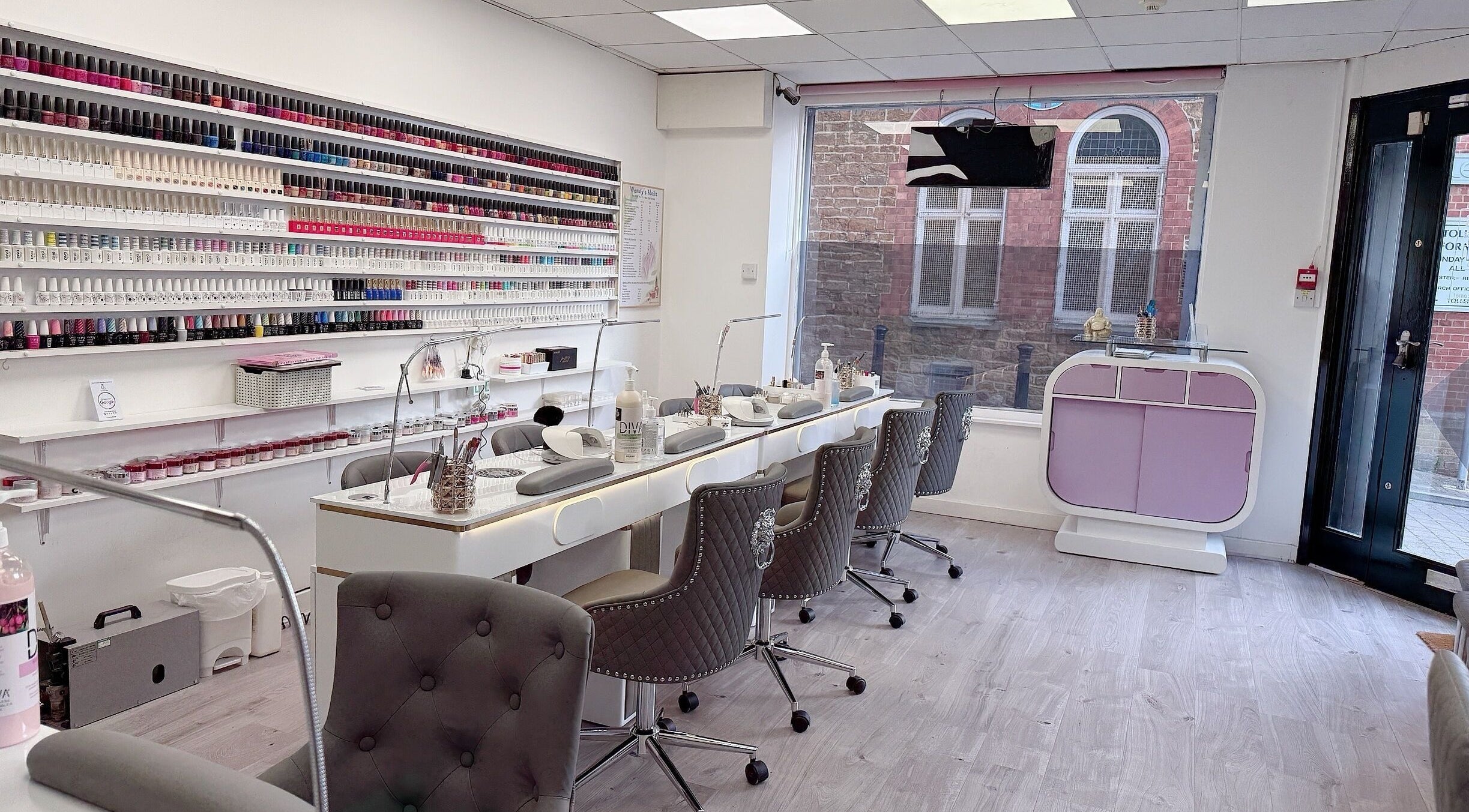 Interior of Wendy’s Nails in Kettering, England, GB showcasing a chic nail bar and wall of colorful polishes.