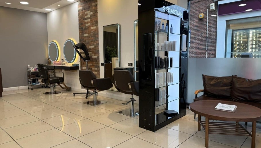 Modern interior of Hair Plus Southgate in London, England, GB with stylish seating and hair styling stations.