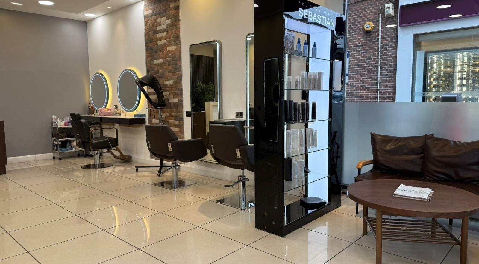 Modern interior of Hair Plus Southgate in London, England, GB with stylish seating and hair styling stations.