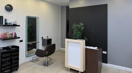 Modern salon interior at Hair Plus Southgate, London, England, GB, featuring stylish decor and hair styling station.