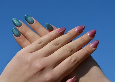 Sparkling green and pink nails at The Tipsy Pixie, Roodepoort, Gauteng, ZA under a clear blue sky.