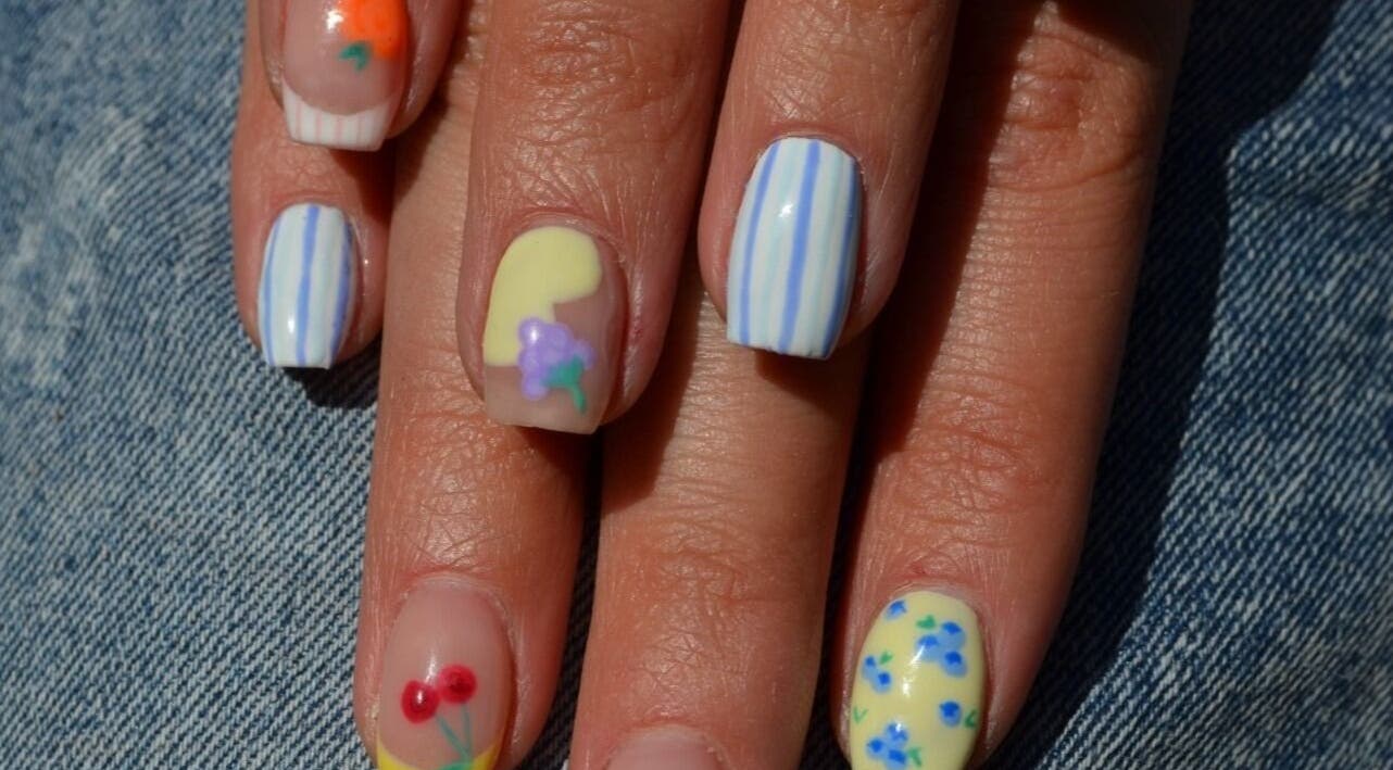 Colorful nail art with floral designs at The Tipsy Pixie in Roodepoort, Gauteng, ZA.