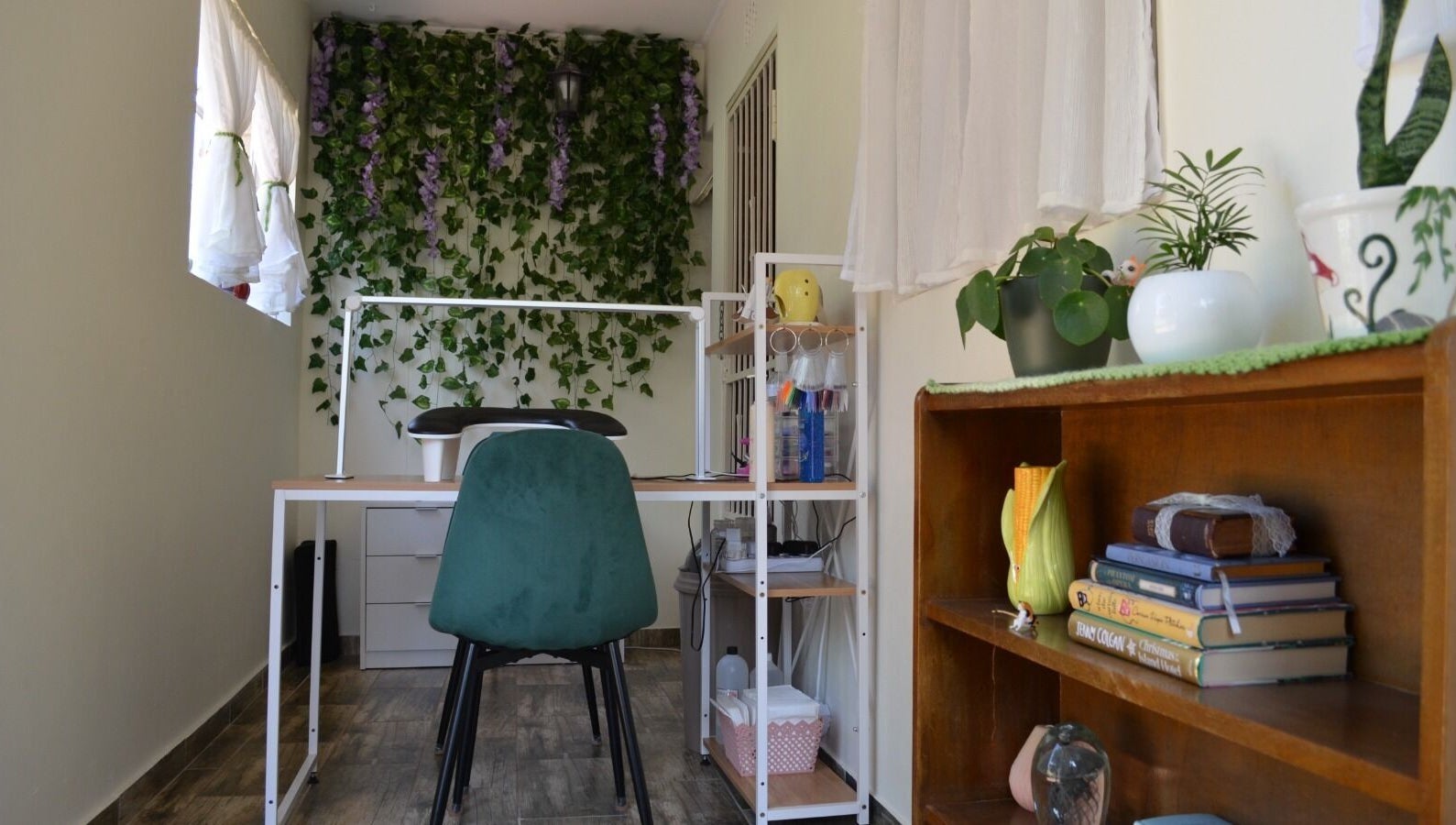 The Tipsy Pixie in Roodepoort, Gauteng, ZA offers a cozy space with desk, green chair, and lush greenery.
