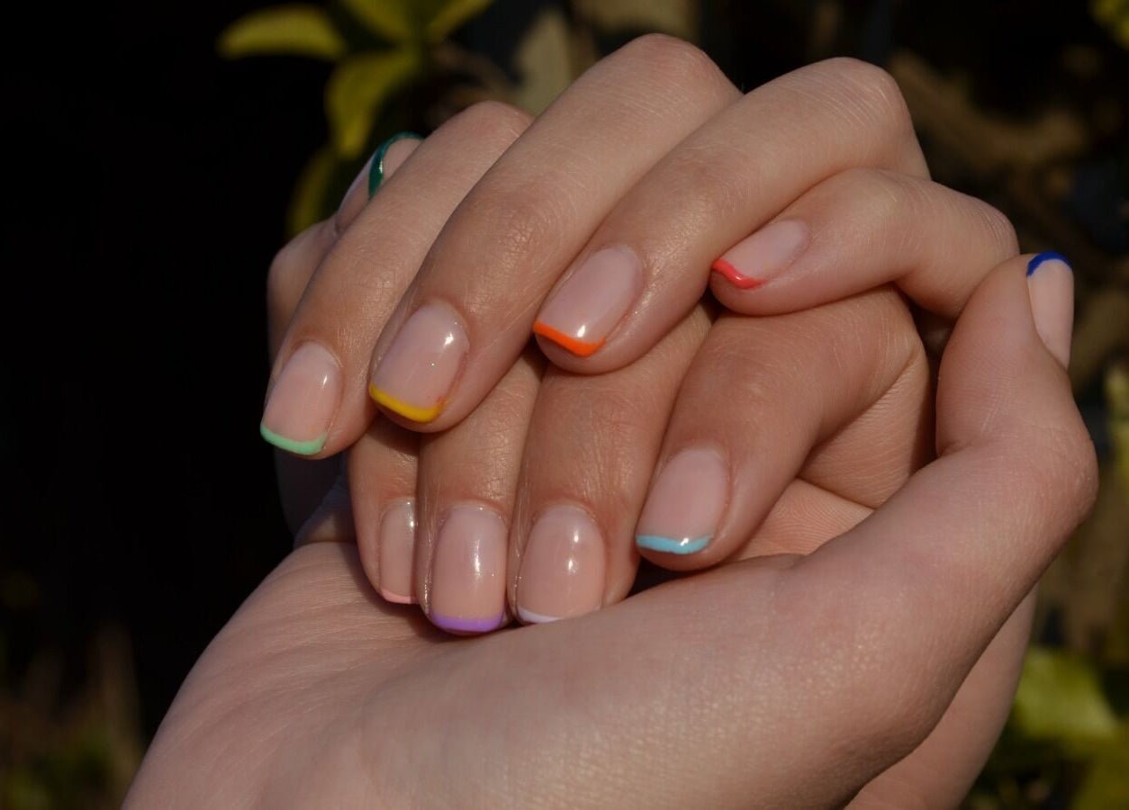 Colorful manicured nails at The Tipsy Pixie, Roodepoort, Gauteng, ZA, offering vibrant nail design.