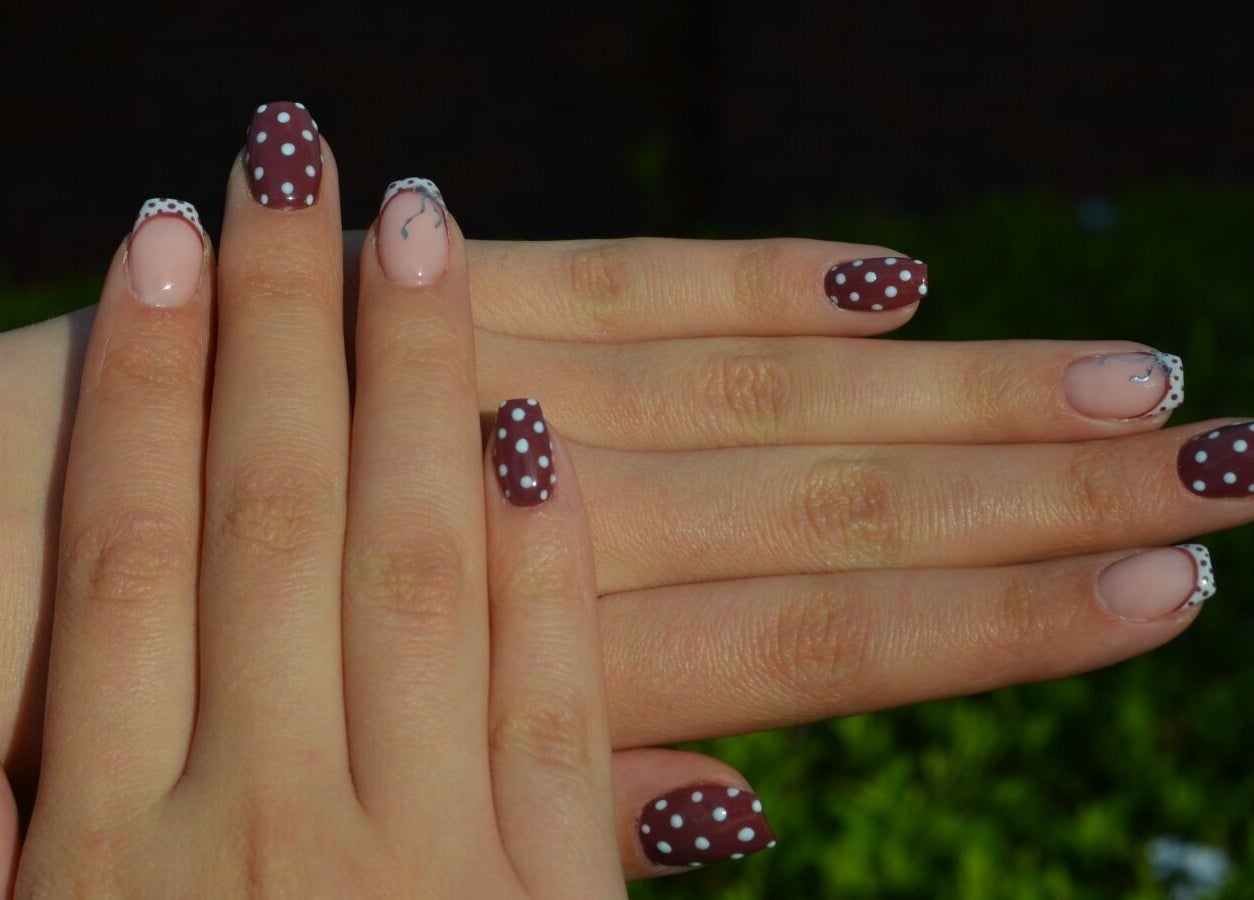 Chic polka dot nail art at The Tipsy Pixie, Roodepoort, Gauteng, ZA, showcasing intricate hand designs.