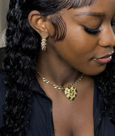 A woman with styled hair and jewelry at The Lace Boss, Philipsburg, SX, exudes elegance and sophistication.