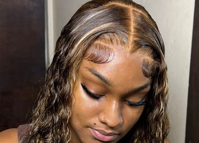 Styled hair at The Lace Boss, Philipsburg, showcasing elegant waves and sleek baby hairs.