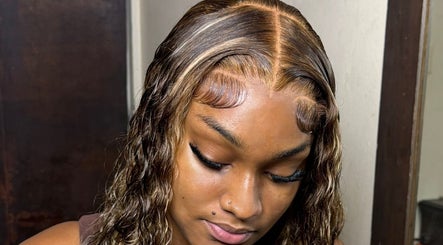 Styled hair at The Lace Boss, Philipsburg, showcasing elegant waves and sleek baby hairs.