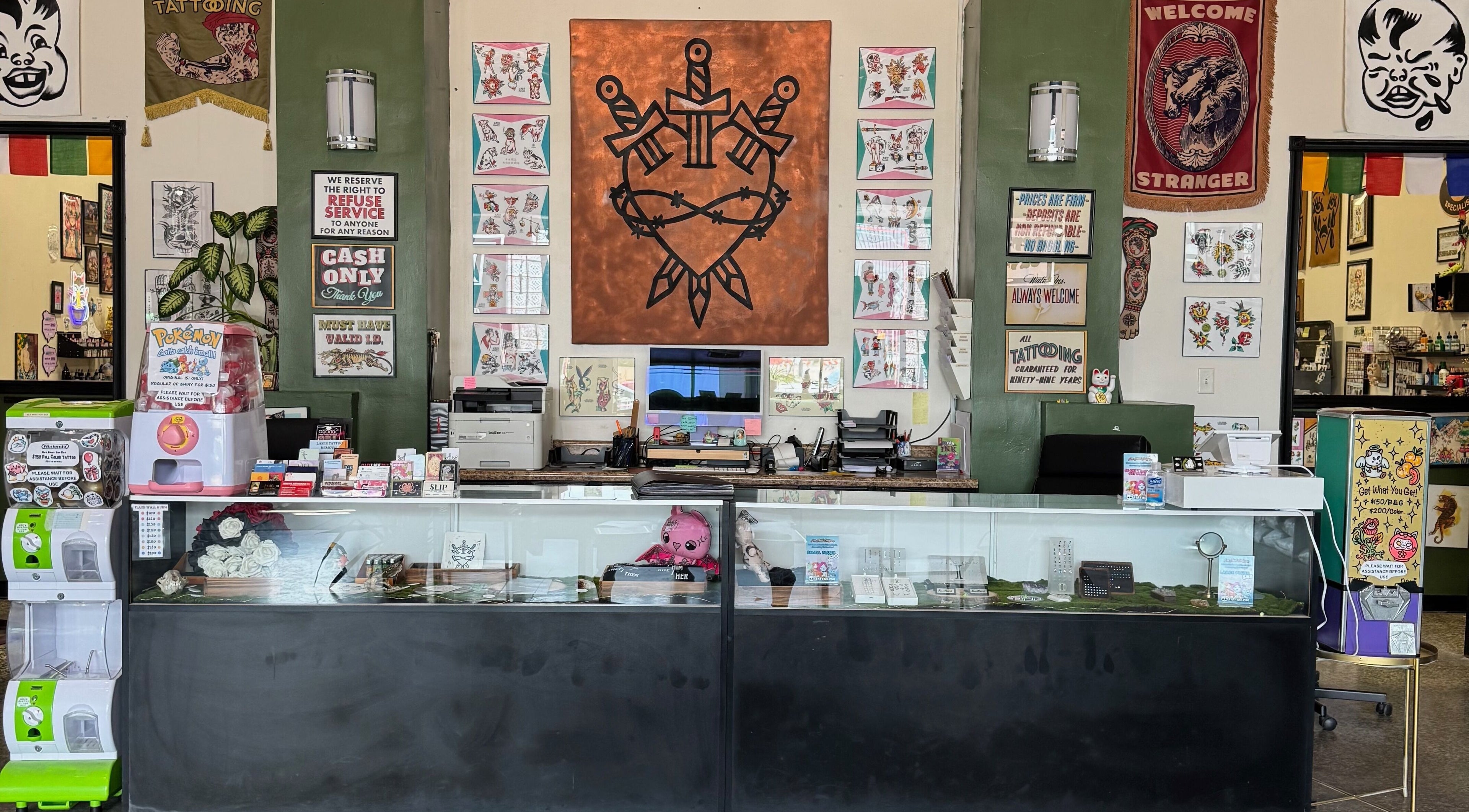 Welcome desk at I'm Just Saiyan Norfolk inside Tender Heart Tattoo, Norfolk, Virginia, US, showcasing tattoo art.