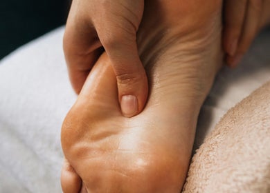 Reflexology session at Tychea Holistic & Wellness, Tampa, Florida, US. A hand massaging a foot for relaxation.