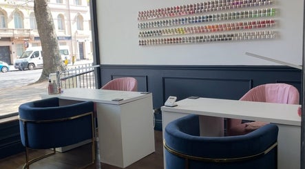 Interior of Nails By Kendall, Doncaster with modern manicure stations and colorful polish display.
