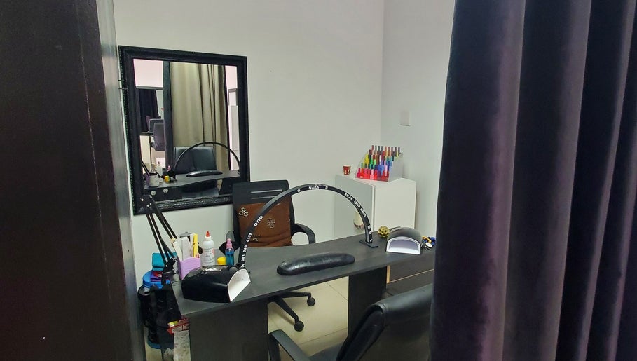 Nail salon station at QNails, Randburg, Gauteng, ZA with supplies and equipment for manicures.