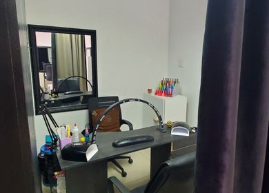 Nail salon station at QNails, Randburg, Gauteng, ZA with supplies and equipment for manicures.