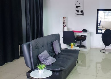 Stylish waiting area at QNails, Randburg, Gauteng, ZA with black chairs and minimal decor.