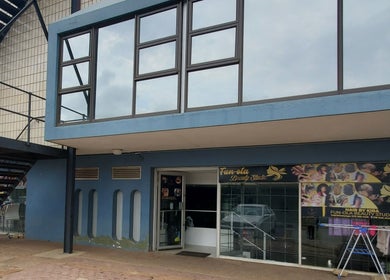 Entrance of QNails in Randburg, Gauteng, ZA, displaying stylish blue facade and signage.