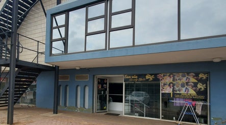 Entrance of QNails in Randburg, Gauteng, ZA, displaying stylish blue facade and signage.