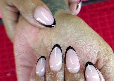 Sleek black French tips on manicured nails at QNails, Randburg, Gauteng, ZA.