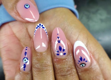 Elegant hand-painted nails at NailsbyQ, Randburg, Gauteng, ZA showcase intricate blue designs.
