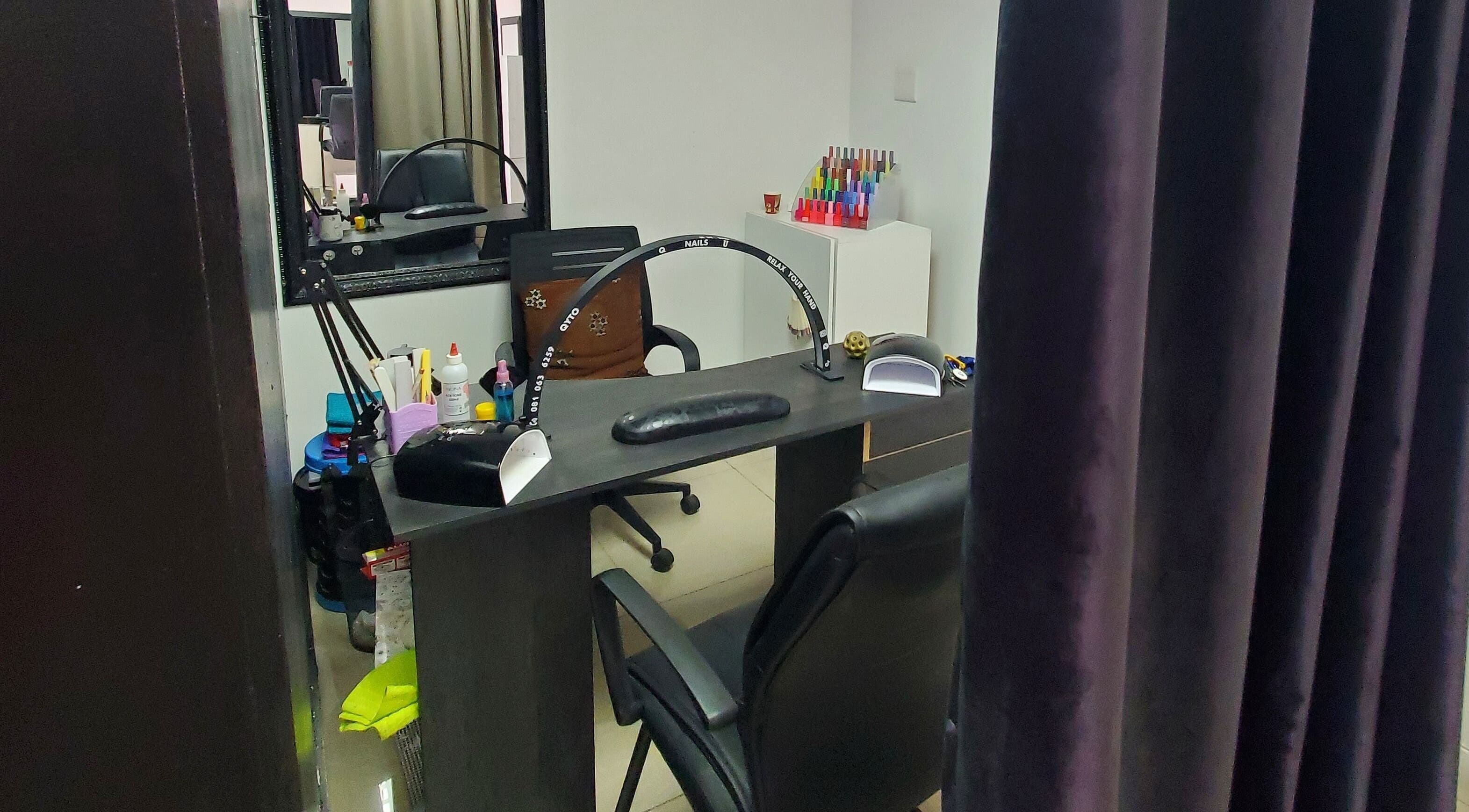 Nail station interior at NailsbyQ, Randburg, Gauteng, ZA featuring comfortable seating and nail tools.