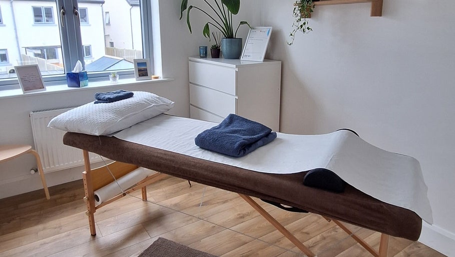 Relaxing massage room at Neartú Massage, Mungret, County Limerick, IE, with a massage table and calming decor.