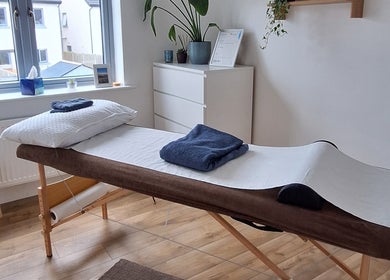 Relaxing massage room at Neartú Massage, Mungret, County Limerick, IE, with a massage table and calming decor.