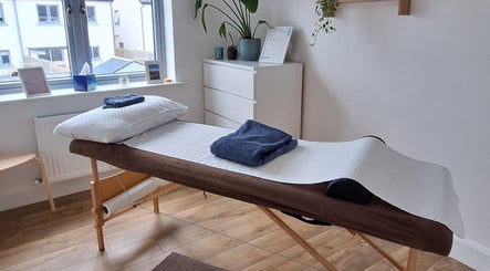 Relaxing massage room at Neartú Massage, Mungret, County Limerick, IE, with a massage table and calming decor.