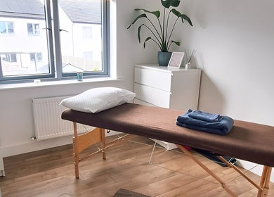 Relaxing massage room at Neartú Massage, Mungret, County Limerick, IE, with soft lighting and decor.