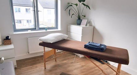 Relaxing massage room at Neartú Massage, Mungret, County Limerick, IE, with soft lighting and decor.
