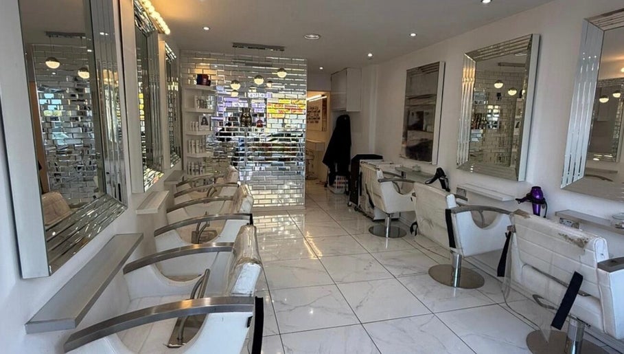 Chic interiors of HairbyBryanMurphy salon in Glasgow, Scotland, GB, highlighting modern styling chairs and mirrors.