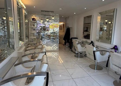 Chic interiors of HairbyBryanMurphy salon in Glasgow, Scotland, GB, highlighting modern styling chairs and mirrors.