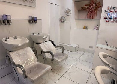 Modern wash stations and chairs at HairbyBryanMurphy in Glasgow, Scotland, GB showcasing sleek salon design.